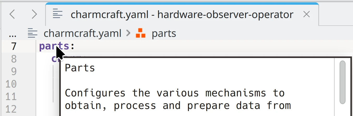 A charmcraft.yaml file open in kate editor showing a hint for the parts key.
